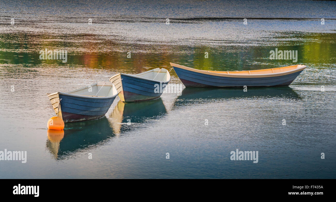 Three Dory boats floating in the harbor Stock Photo