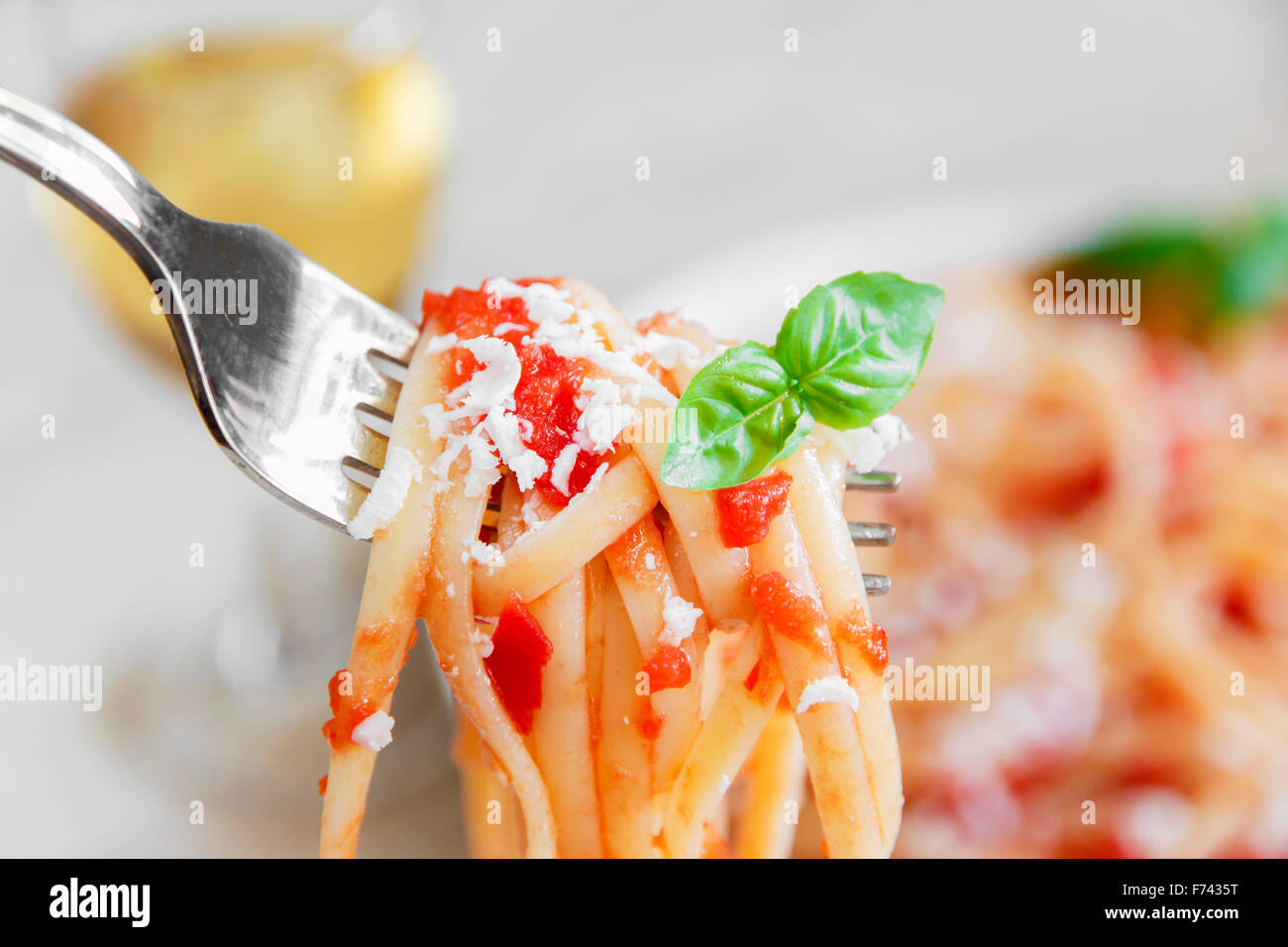 linguine pasta with tomato sauce and cheese on a plate Stock Photo