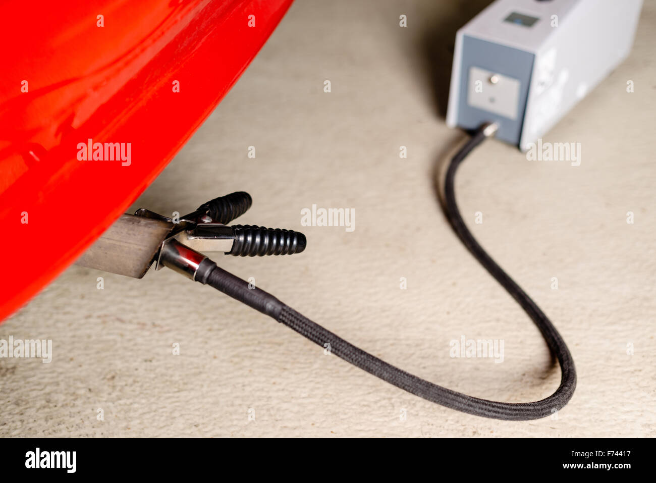 Sensor device measuring exhausts of a car in garage Stock Photo Alamy