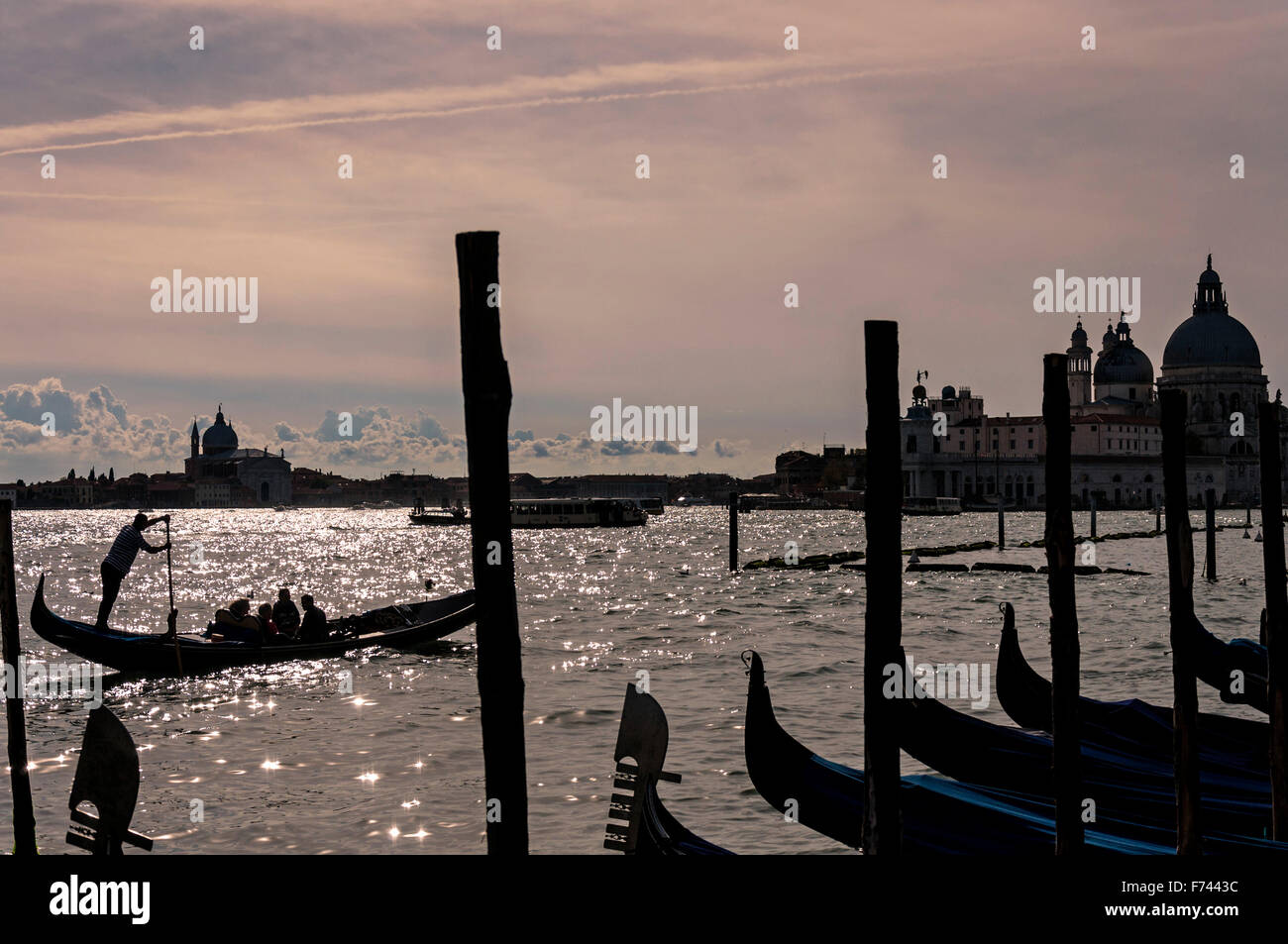 Gondolier gondolas in Venice, Italy. Silhouettes Stock Photo