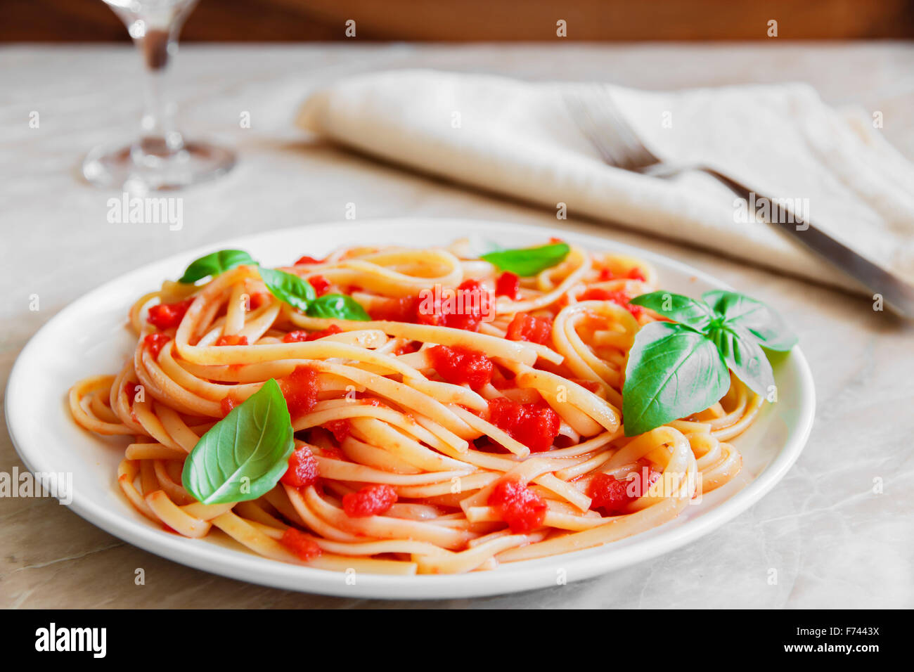 Linguine pasta in tomato sauce on a plate Stock Photo