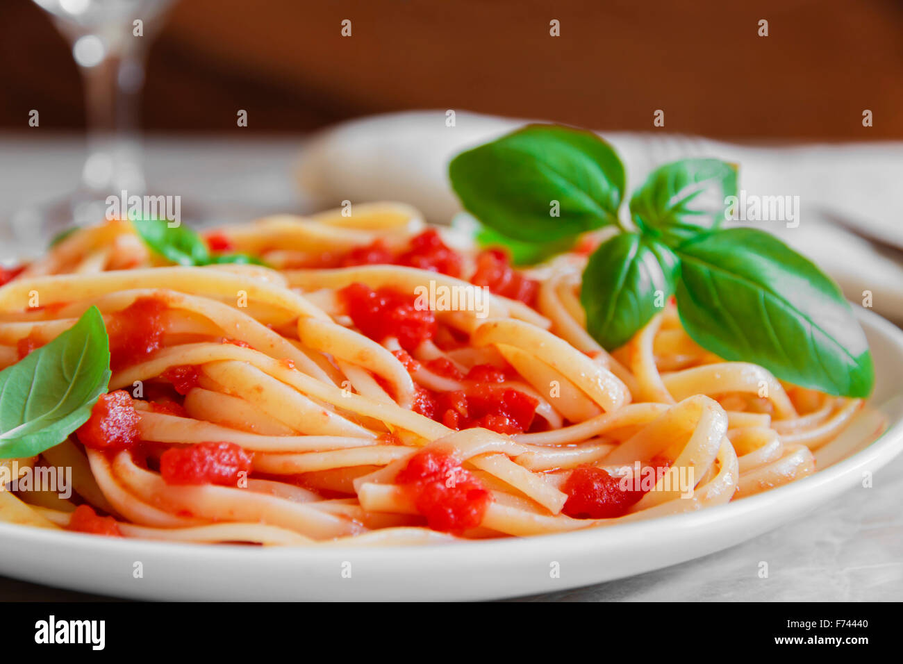 Linguine pasta in tomato sauce on a plate Stock Photo