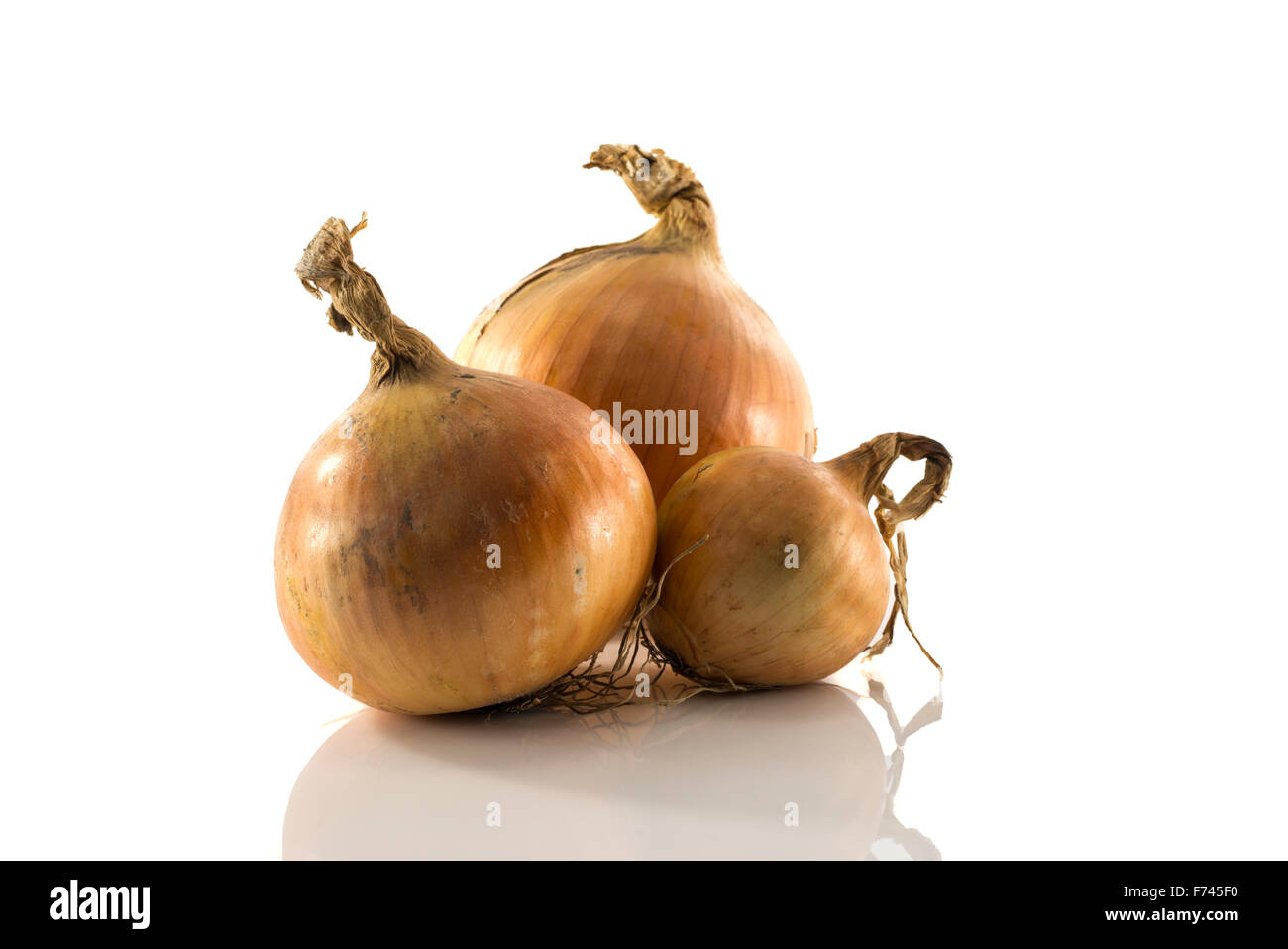 three onion isolated on white background Stock Photo - Alamy