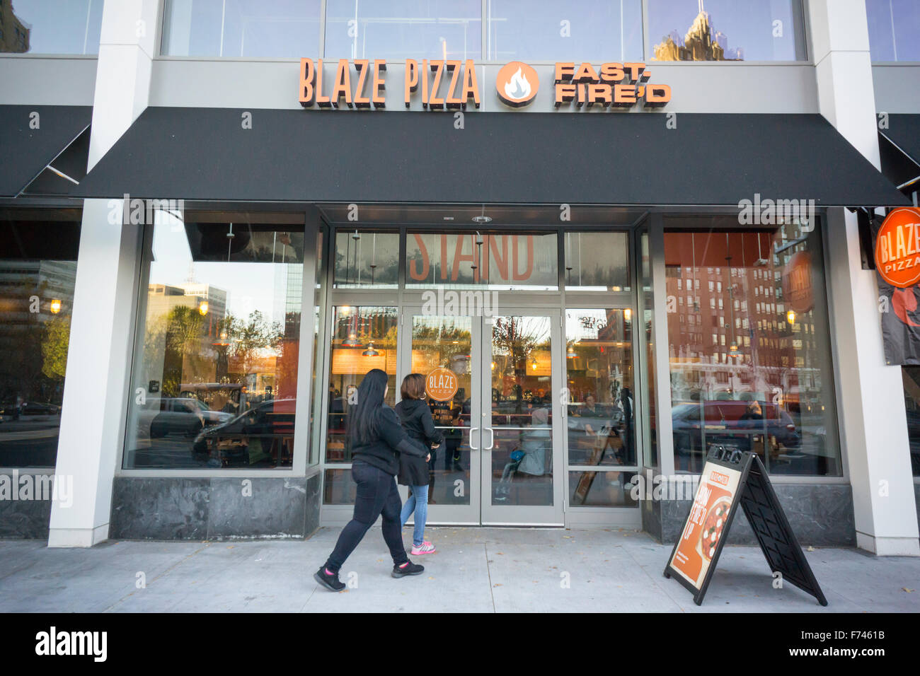 Customers enter the newly opened Blaze Pizza franchise in Newark, NJ on Saturday, 23, 2015