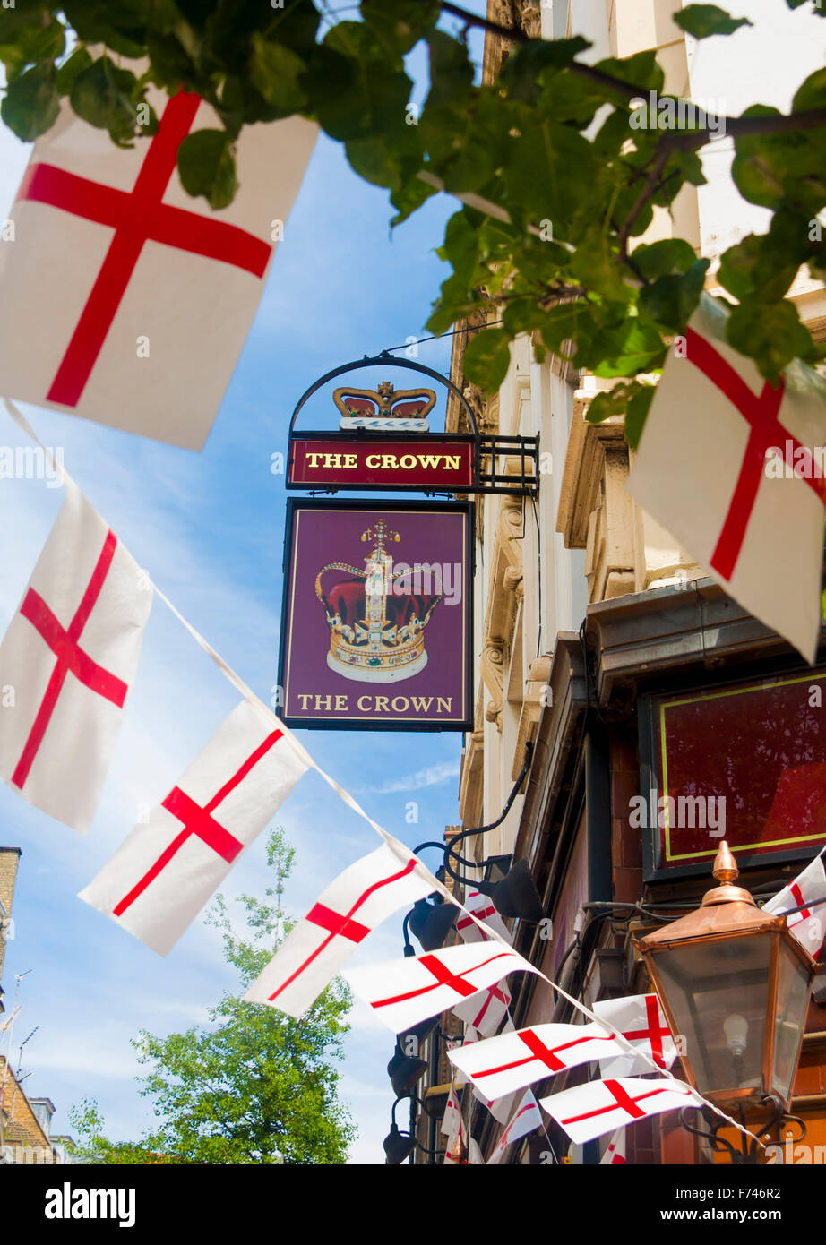 English flags St George Cross of St George flying outside The Crown pub Seven Dials Covent Garden London England UK Stock Photo