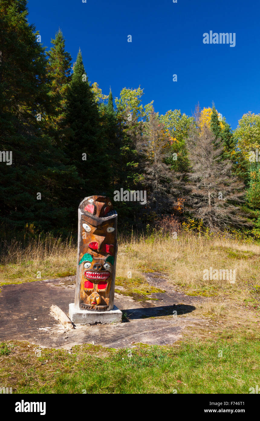A small wooden Totem Pole near Whitefish Lake.  Algonquin Provincial Park, Ontario, Canada. Stock Photo