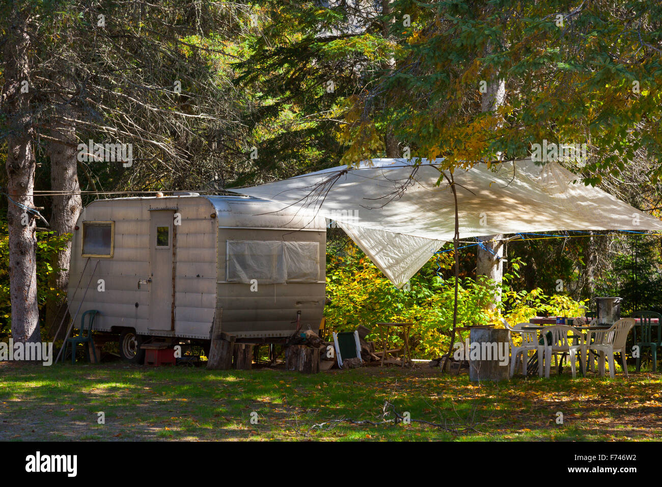 A vintage Camper Trailer set up at a campsite in Algonquin Provincial Park. Ontario, Canada. Stock Photo