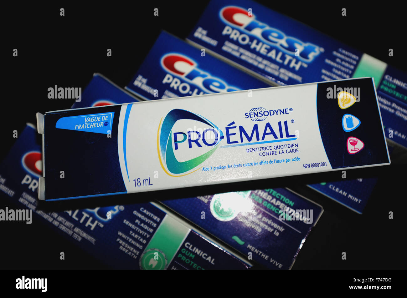 Boxes of Pronamel and Crest toothpaste photographed against a black