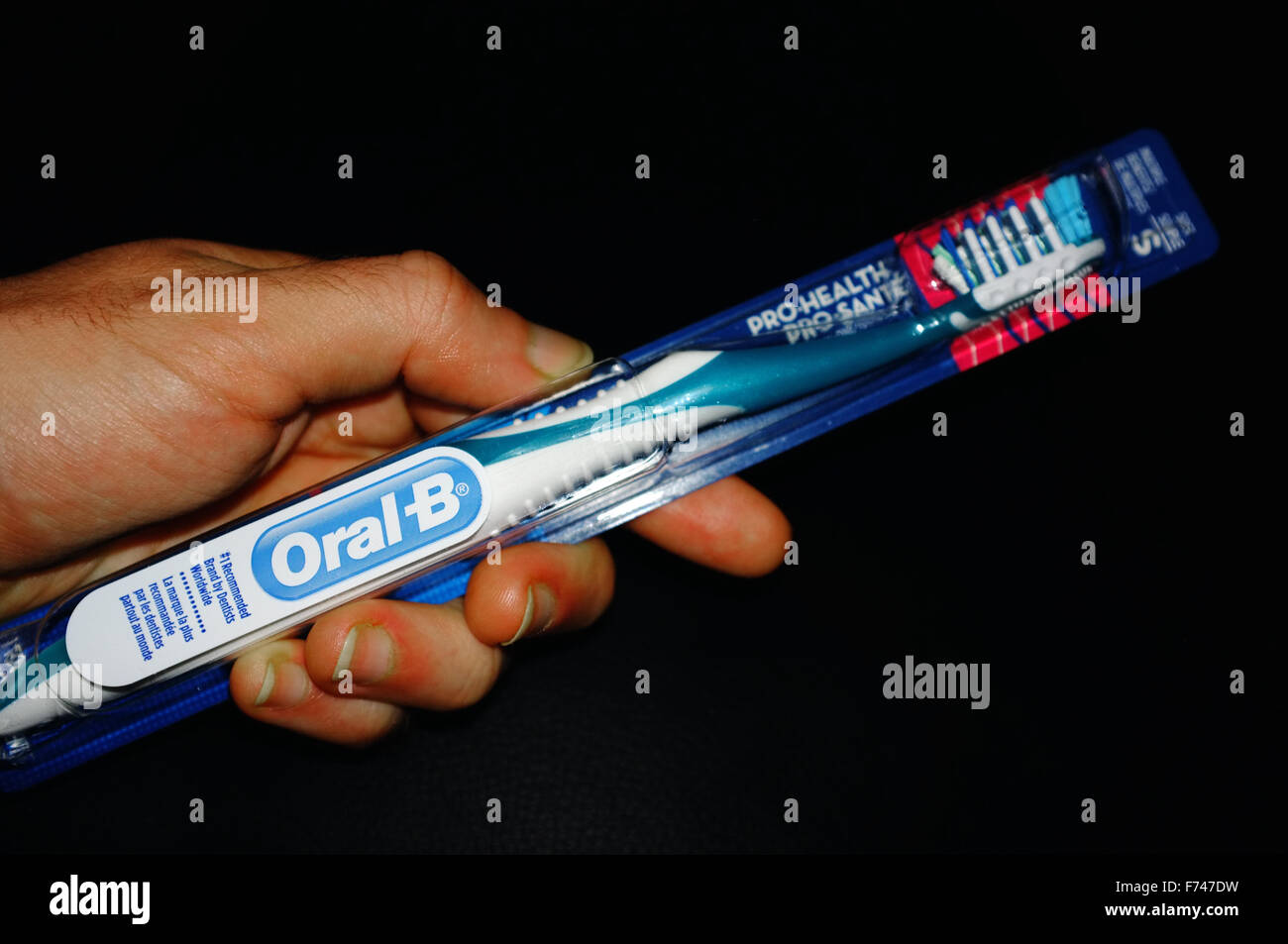 A Hand Holding An Oral B Toothbrush In Its Packaging Photographed Against A Black Background Stock Photo Alamy A Hand Holding An Oral B Toothbrush In Its Packaging Photographed Against A Black Background Stock Photo Alamy