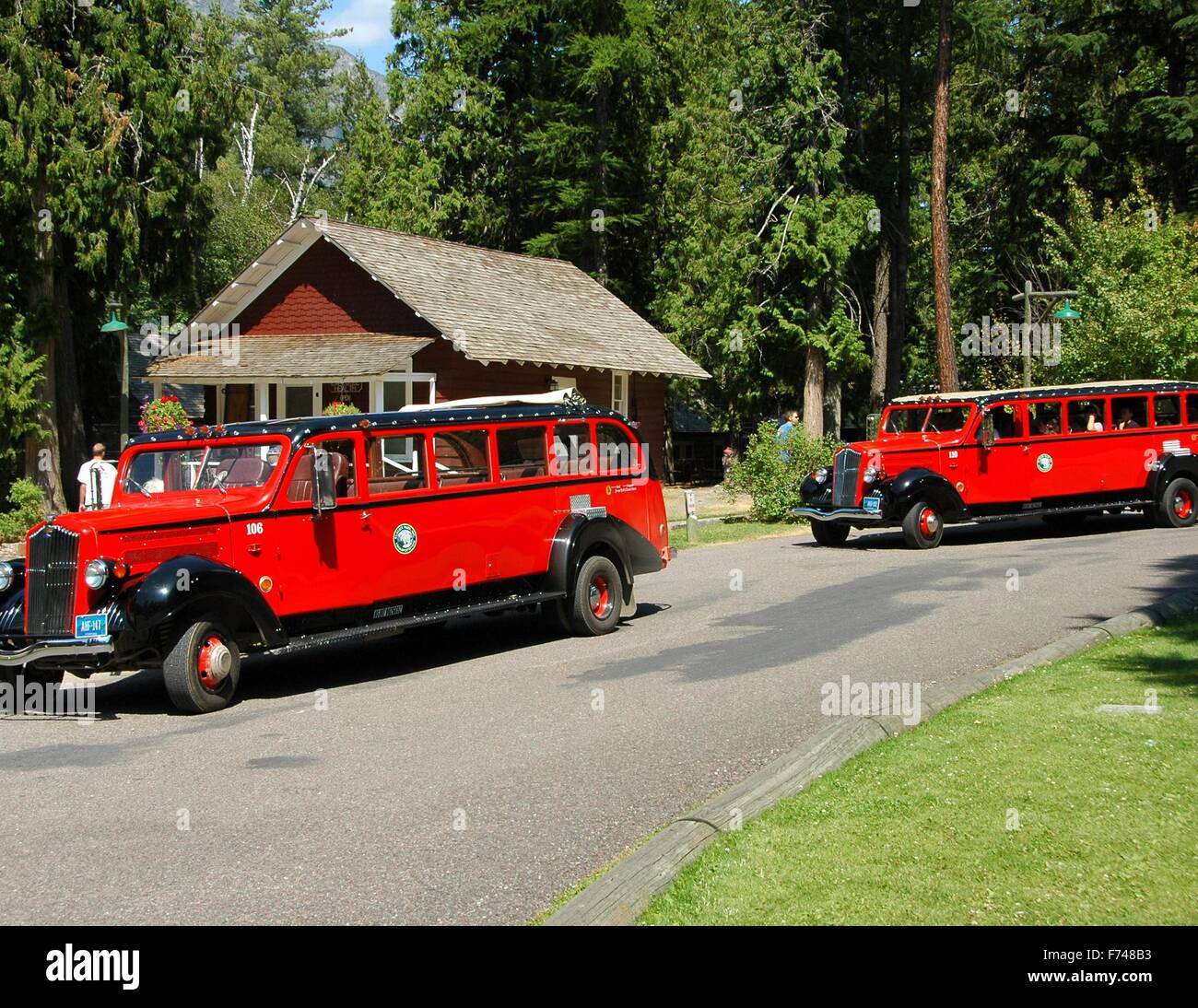 The red Jammer buses are an iconic image of Glacier National Park. Stock Photo