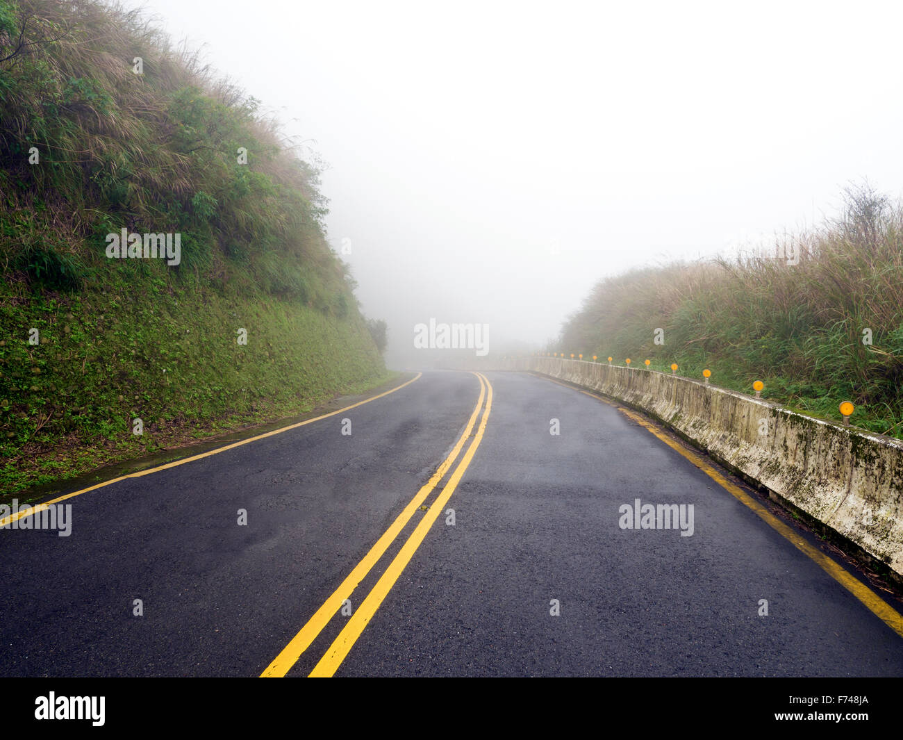 Road in national yangming mountain park in fog weather,Taipei,Taiwan Stock Photo