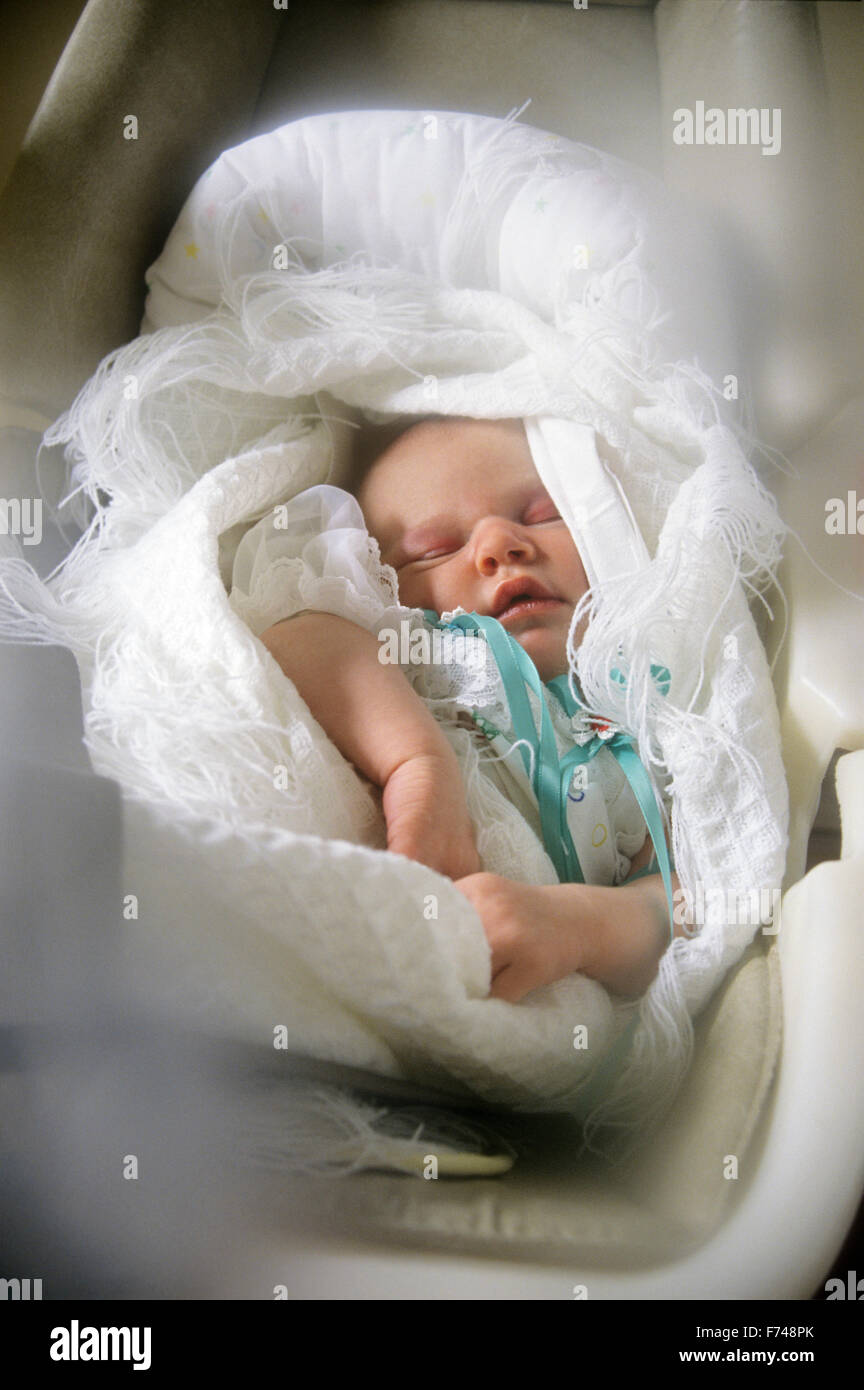 2 day old sleeping infant in 'car seat' Stock Photo