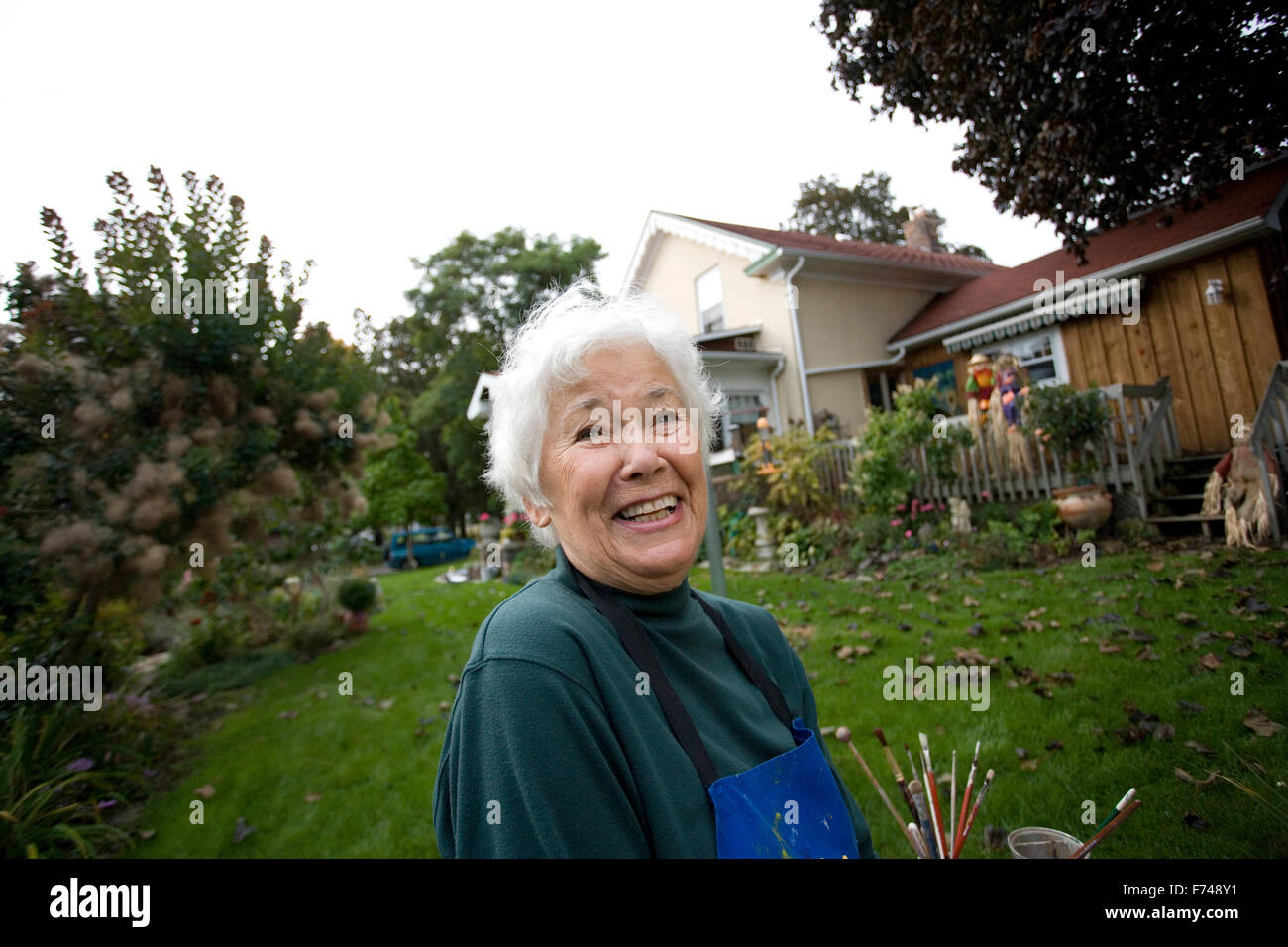 elderly artist painting in garden Stock Photo