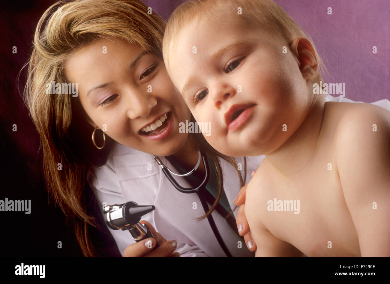doctor examining child patient Stock Photo