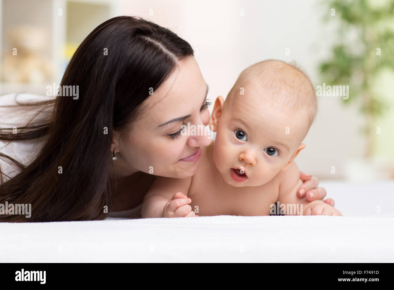 happy mother hugging and kissing her baby Stock Photo