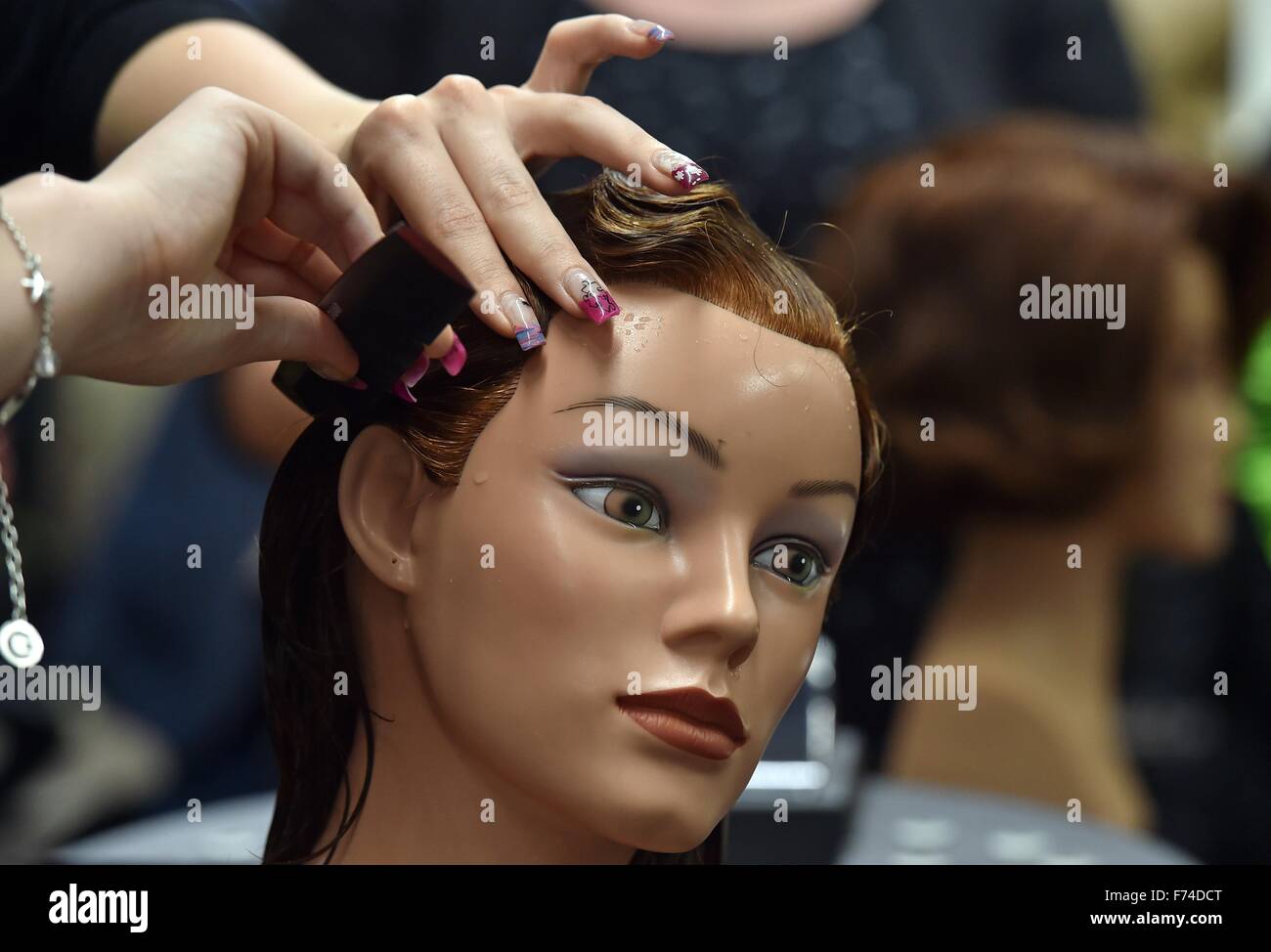 Bitterfeld, Germany. 9th Nov, 2015. A hairdresser apprentice practices