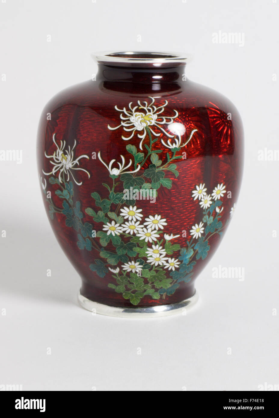 Small Ando Hubei silver wire cloisonne vase with silver mounts. The vase of quatrefoil form finely decorated chrysanthemum flowe Stock Photo