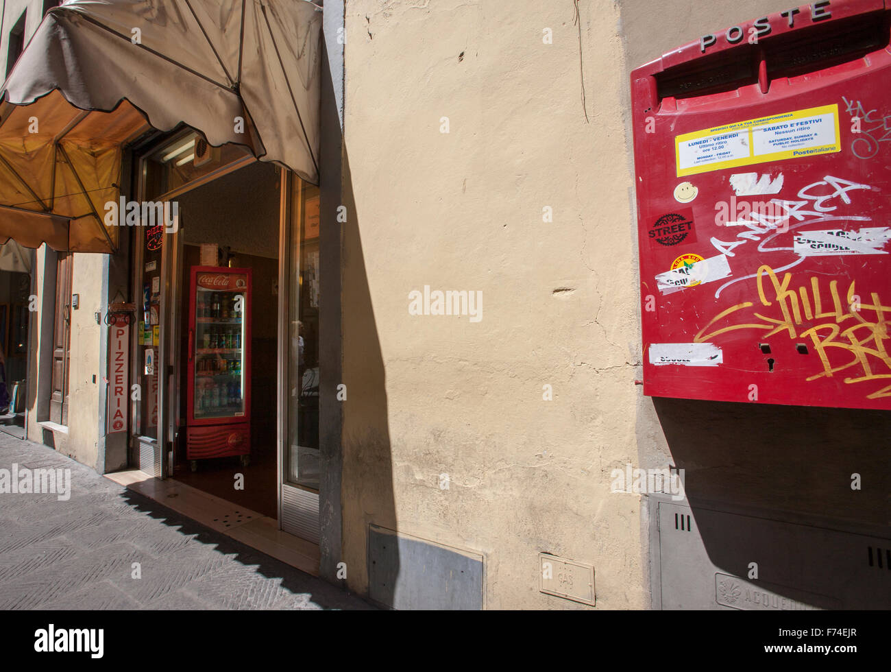 Red letter box post office red coca cola fridge Florence street scene Stock Photo