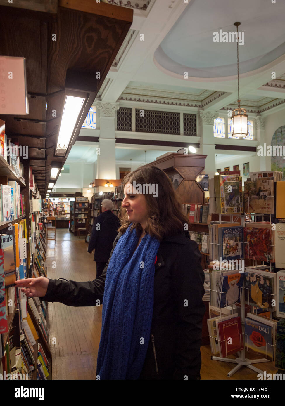 A customer browses the shelves at Munro's Books, a large independent books store in Victoria, British Columbia, Canada. Stock Photo