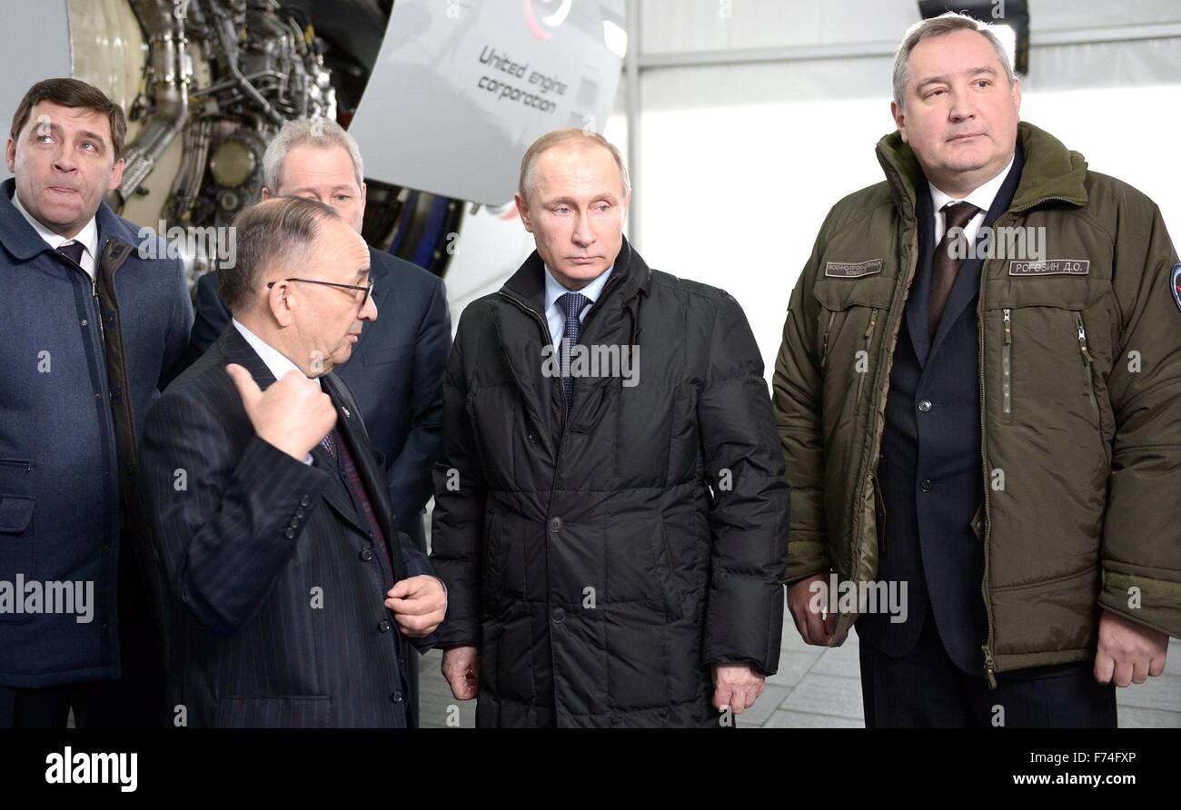Russian President Vladimir Putin is given a tour of the UVZ  military design center with Deputy Prime Minister Dmitry Rogozin, right, and Perm Territory Governor Viktor Basargin, back left,  November 25, 2015 in Nizhny Tagil, Russia. The center develops and builds military hardware including the UVZ armored fighting vehicles, T-90 tank and upgrades to the T-72 battle tank. Stock Photo