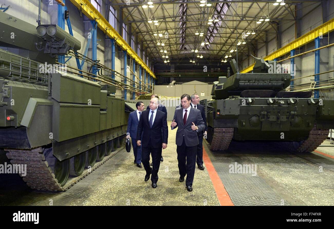 Russian President Vladimir Putin is given a tour of the UVZ  military design center by General Director Andrei Terlikov November 25, 2015 in Nizhny Tagil, Russia. The center develops and builds military hardware including the UVZ armored fighting vehicles, T-90 tank and upgrades to the T-72 battle tank. Stock Photo