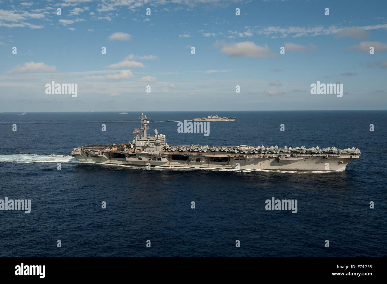 US Navy Nimitz-class aircraft carrier USS Ronald Reagan is underway in formation with Japan Maritime Self-Defense Force ships during Annual Exercise 16 November 23, 2015 off the coast of Japan. Stock Photo