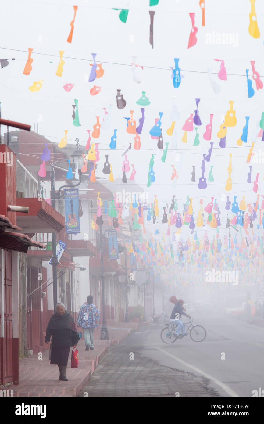 Foggy morning on a street decorated with guitar cutouts in Paracho, Michoacan, Mexico. Stock Photo