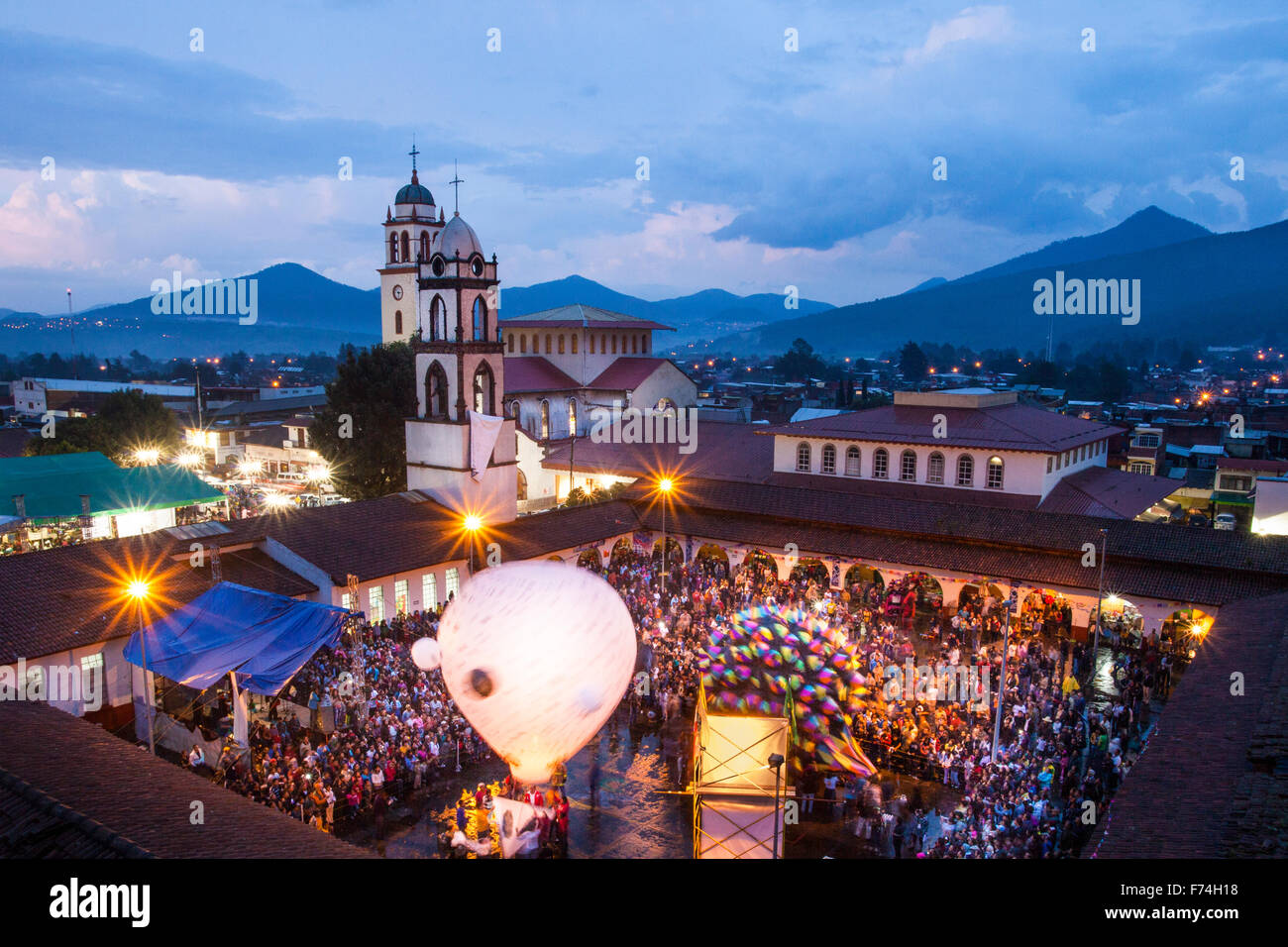 The plaza of Paracho, Michoacan, Mexico filled with spectators and large sky lanterns during the Globo Cantoya festival. Stock Photo