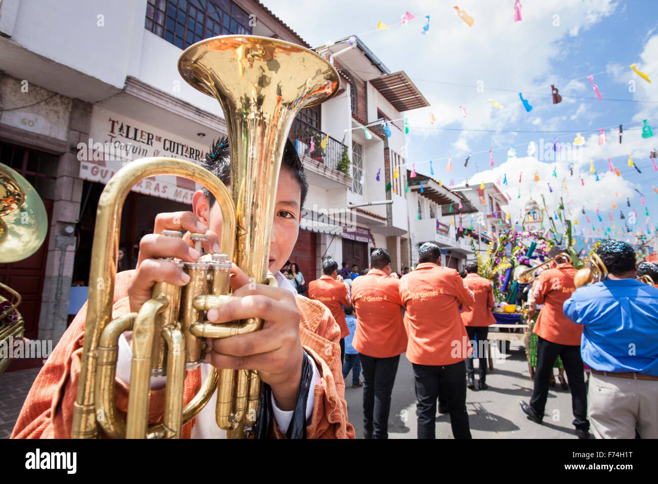 A young baritone player turns around during the Guitar Festival parade in Paracho, Michoacan, Mexico. Stock Photo