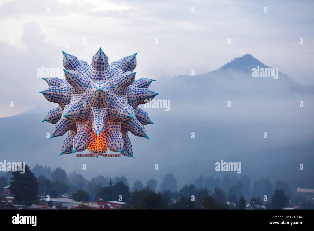 A large sky lantern floats towards a mountain outside of Paracho, Michoacan, Mexico during the annual Globos de Cantoya festival Stock Photo