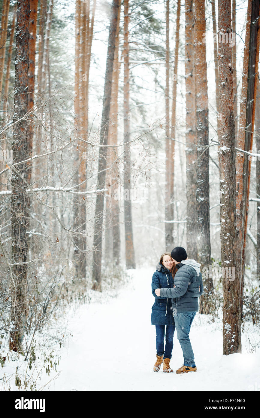 Young Couple Embracing in Winter Forest. Winter Vacations. Weekend