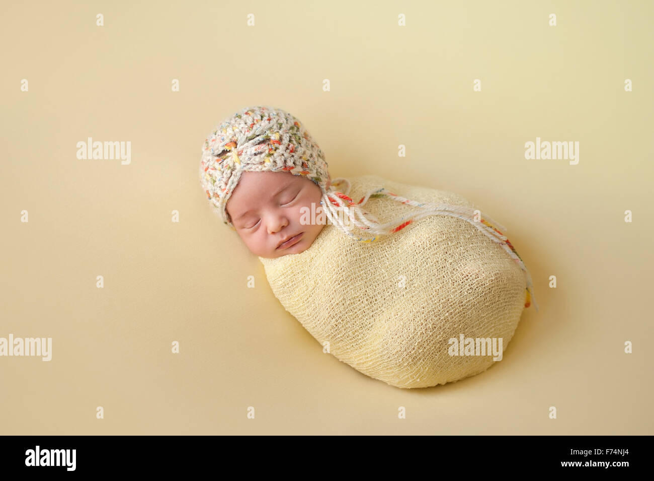 A portrait of a beautiful, two week old, newborn baby girl wearing a