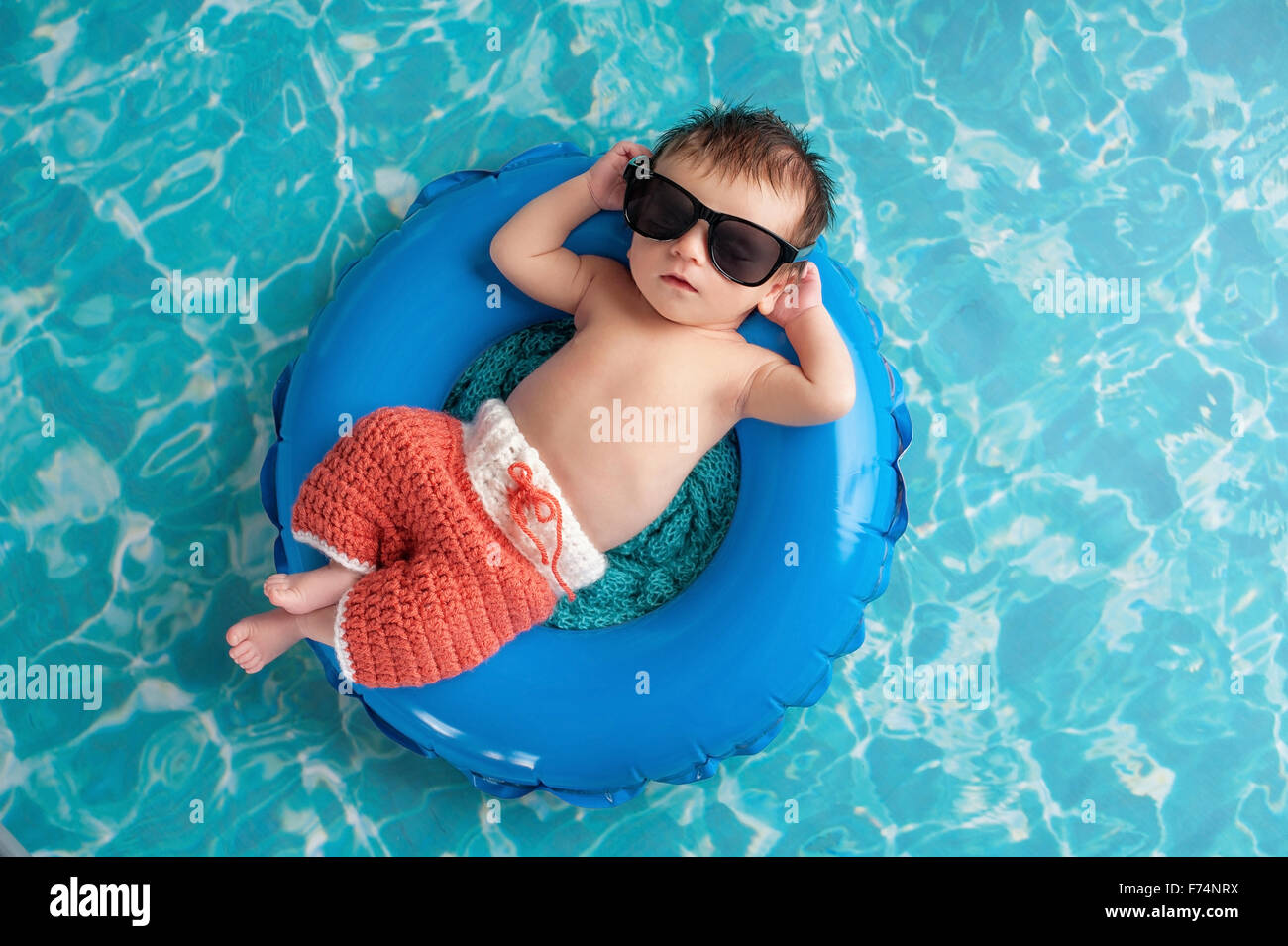 Baby Boy Sleeping on a Tiny Inflatable Swim Ring Stock Photo