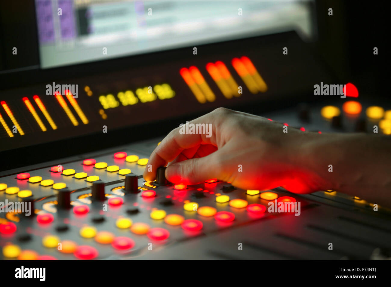 Male hand on control Fader on Film Mixing console Stock Photo - Alamy