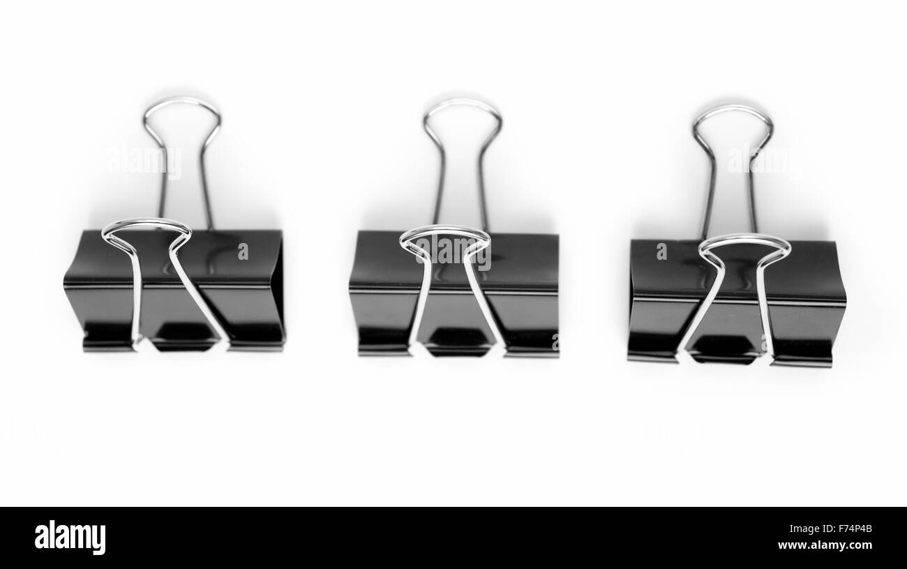 Three black metal clips Stock Photo Alamy