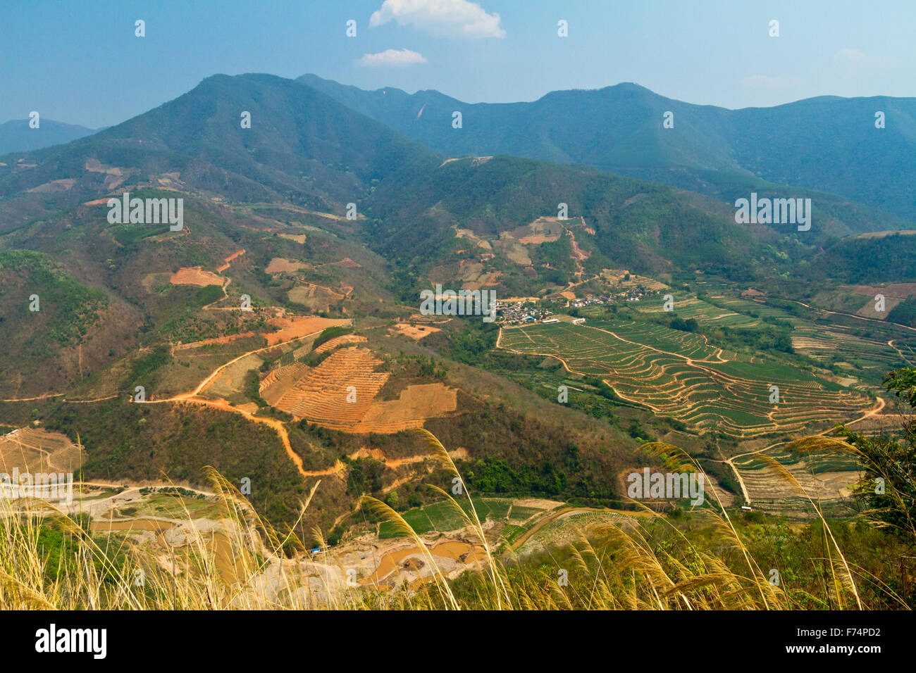 Stunning high view of rice paddies and mountains in Yunnan province, China - Stock Image