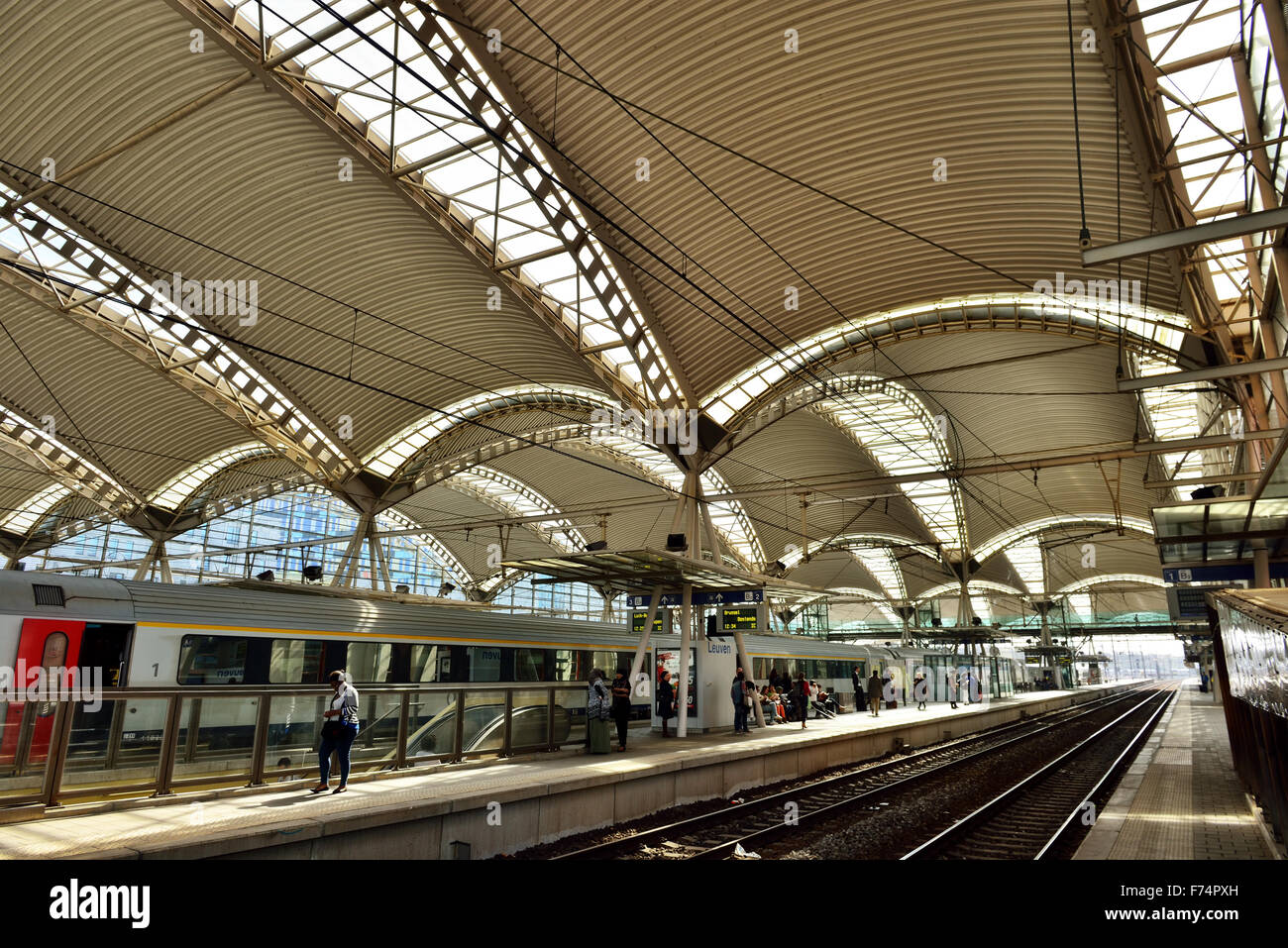 LEUVEN, BELGIUM-APRIL 14, 2015: Train and passengers waiting for departure on railway station in Leuven Stock Photo