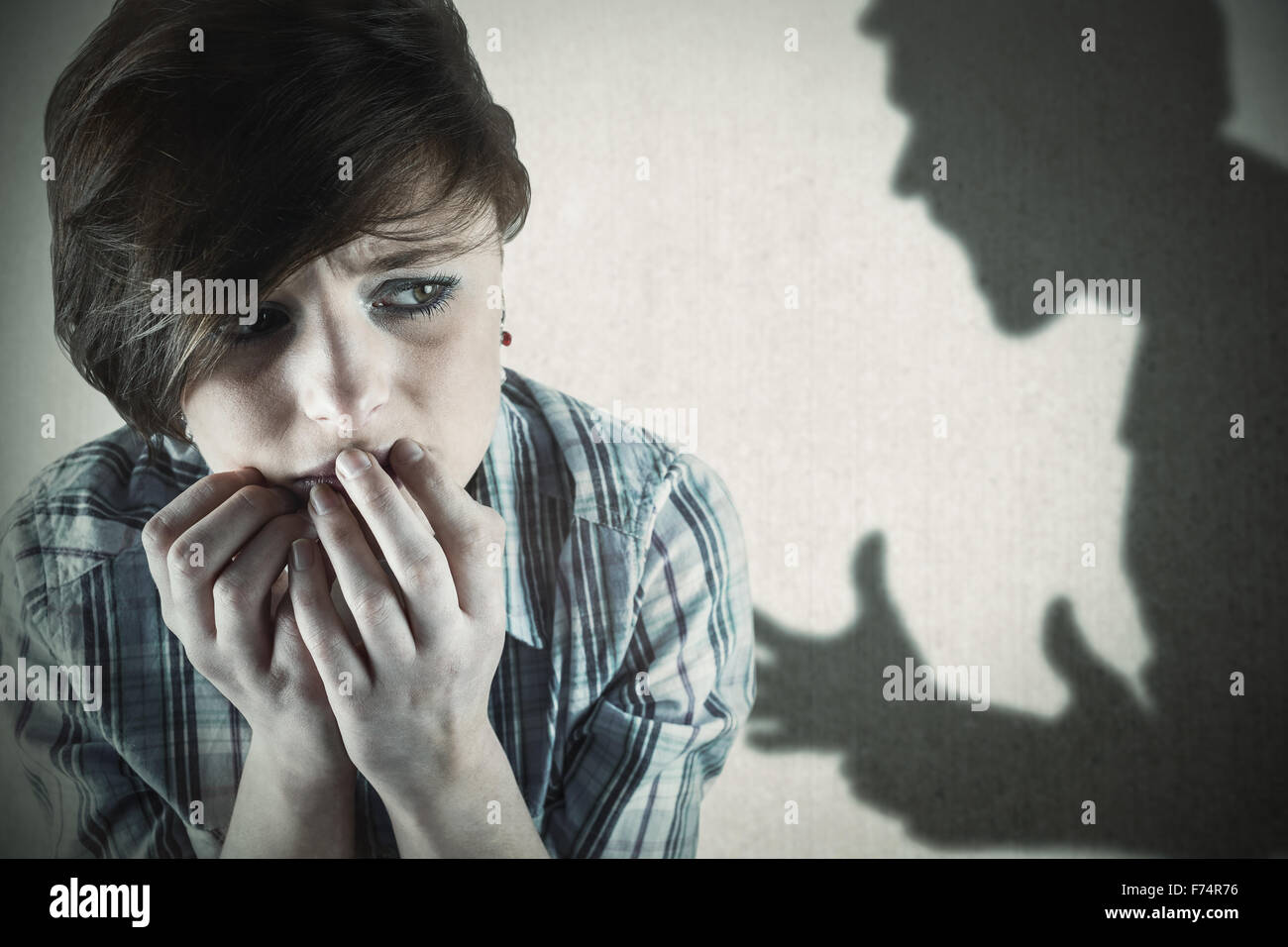 Composite image of worried pretty brunette Stock Photo