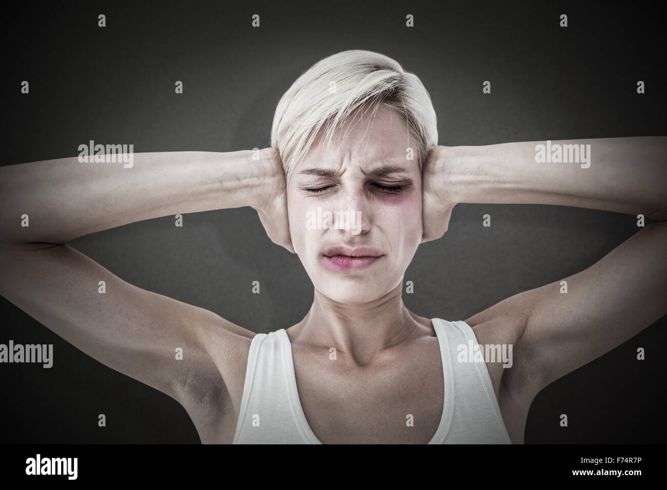 Composite image of upset woman covering her ears Stock Photo Alamy