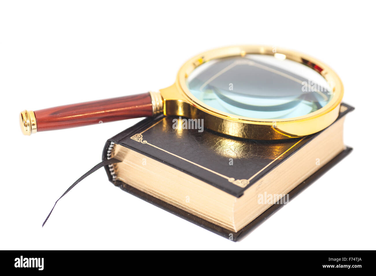 Book with magnifying glass over white background Stock Photo Alamy