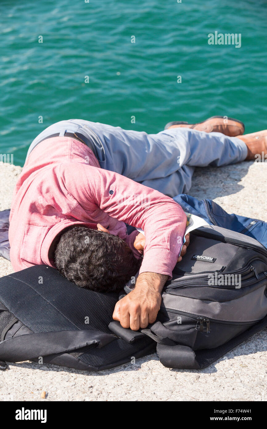 An exhausted Syrian migrantthat is fleeing the war and escaping to Europe, who has landed on the Greek island of Lesvos on the n Stock Photo