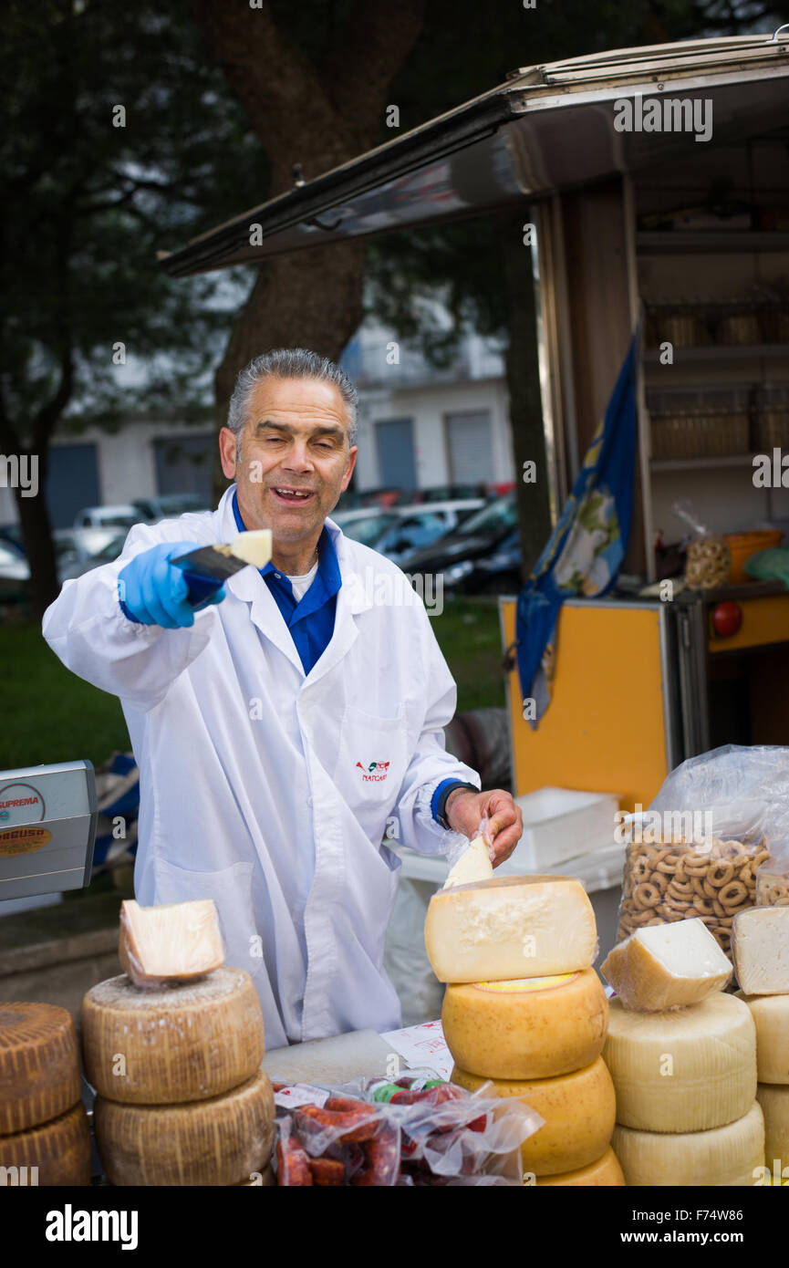 Man selling cheese at Ostuni food market, Ostuni, Puglia, Italy Stock Photo