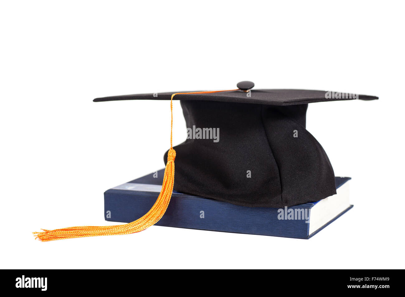 Graduation Cap On  Book isolated Stock Photo