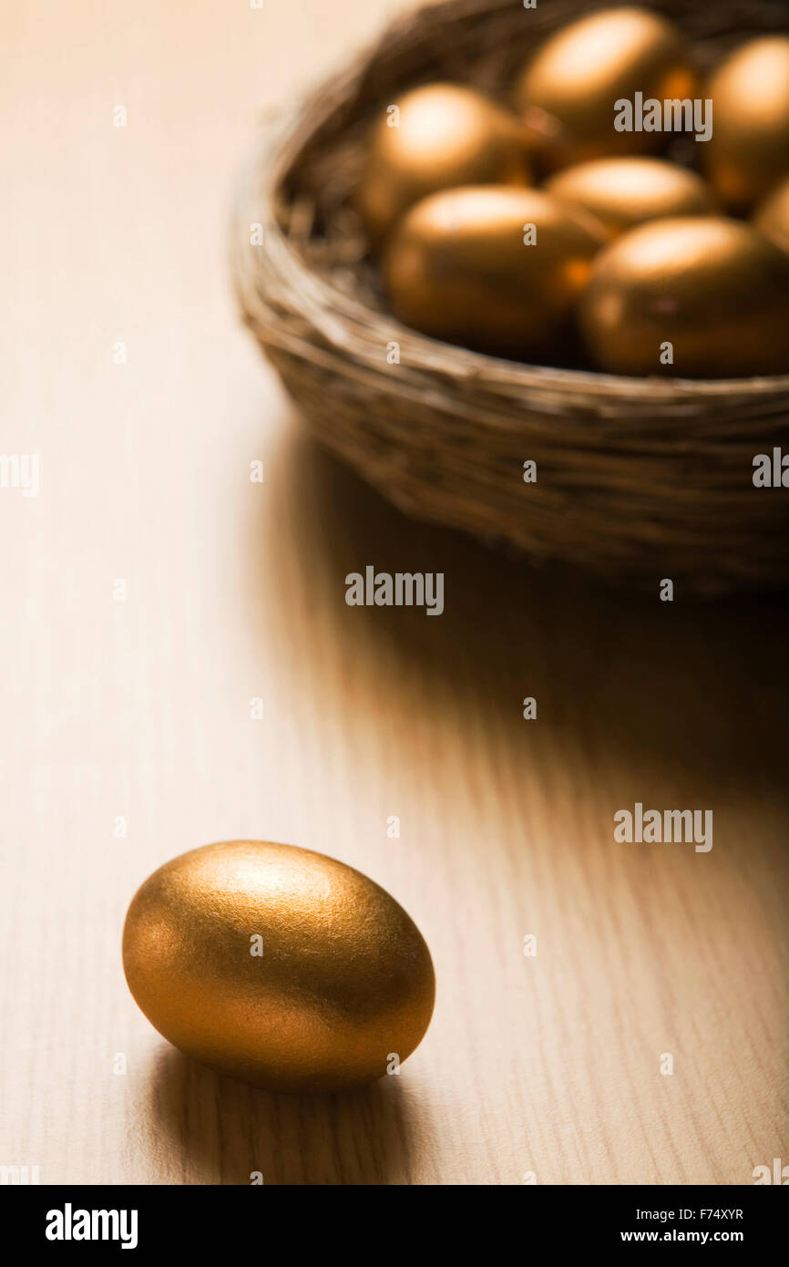 Golden Eggs In Nest Stock Photo - Alamy