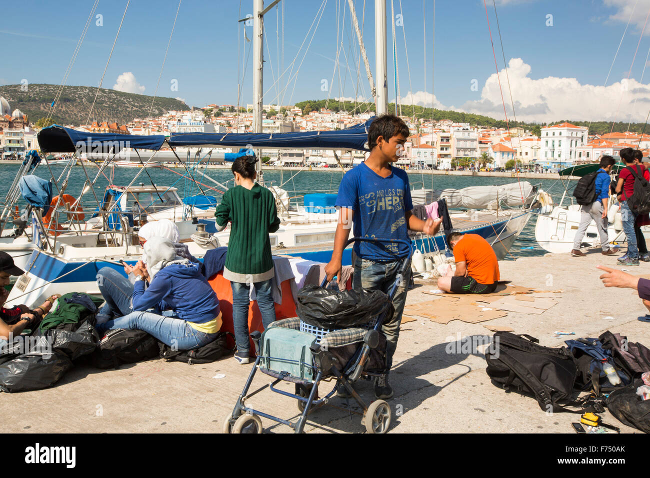 Syrian migrants fleeing the war and escaping to Europe,  who have landed on the Greek island of Lesvos on the north coast at Efthalou. Up to 4,000 migrants a day are landing on the island and overwhelming the authorities. They are traficked by illegal Turkish people traffickers who charge up to $2,000 per person for a half hour ride in an overcrowded inflateable boat from the Turkish mainland to Lesvos. Stock Photo