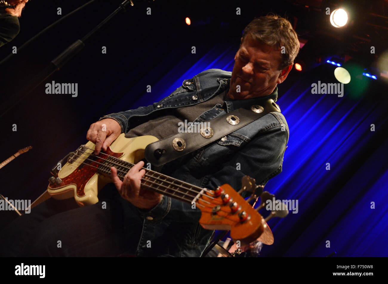 Gerry McAvoy of Band of Friends on stage playing his Fender Precision bass guitar Stock Photo