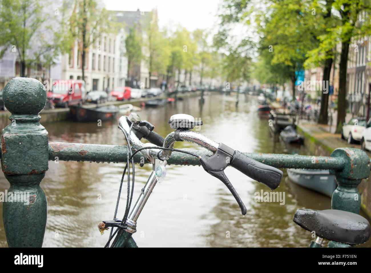 Bicycle parked on a bridge in Amsterdam on a rainy day Stock Photo