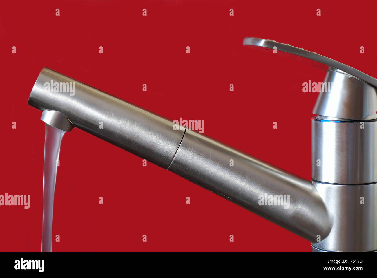 kitchen tap on red background Stock Photo - Alamy