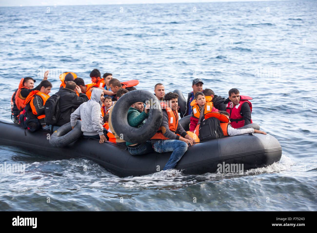 Syrian migrants fleeing the war and escaping to Europe, landing on the Greek island of Lesvos on the north coast at Efthalou. Up to 4,000 migrants a day are landing on the island and overwhelming the authorities. They are traficked by illegal Turkish people traffickers who charge up to $2,000 per person for a half hour ride in an overcrowded inflateable boat from the Turkish mainland to Lesvos. Stock Photo