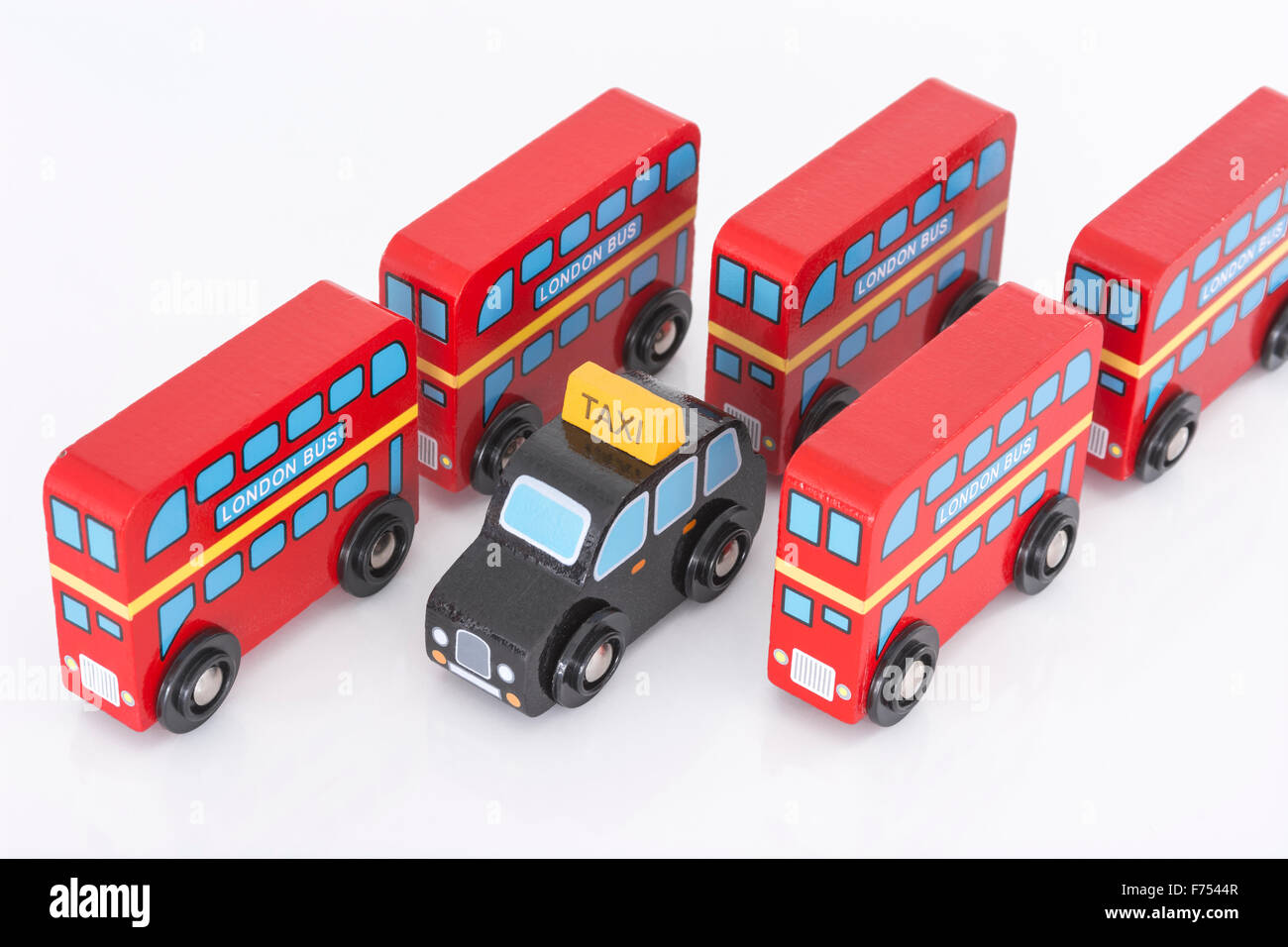 Red London buses & black cab (taxi) wooden toys on white background